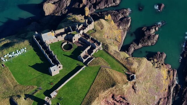 Beautiful cinematic Aerial footage of Dunnottar Castle and Dramatic Cliffs, Stonehaven Scotland &ndash; Historic Medieval Fortress on the North Sea	