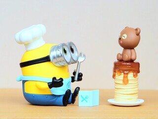 Fototapeta premium Indonesia - February 22, 2026 : Mini toy of action figure at outdoor with blur background. Miniature photography concept design. Minifigure of Minions character from Despicable Me film as a chef.