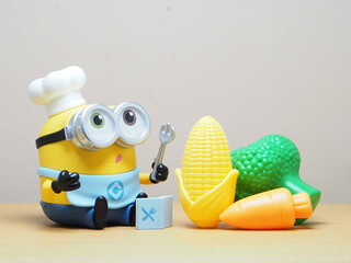 Fototapeta premium Indonesia - February 10, 2026 : Mini toy of action figure at outdoor with blur background. Miniature photography concept design. Minifigure of Minions character from Despicable Me film as a chef.
