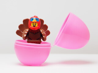 Fototapeta premium Indonesia - February 8, 2026 : Mini toy of action figure at outdoor with blur background. Miniature photography concept design. Minifigure of baby chicken character coming out from egg. New born bird