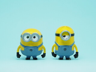 Fototapeta premium Indonesia - November 3, 2025 : Mini toy of action figure at outdoor with blurred background. Miniature photography concept design. Minions character from Despicable Me Cartoon film.