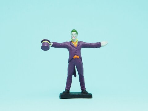 Indonesia - November 3, 2025 : Mini toy of action figure at outdoor with blurred background. Miniature photography concept design. Minifigure of Joker character from DC Comics film.