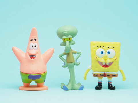 Indonesia - November 3, 2025 : Mini toy of action figure at outdoor with blurred background. Miniature photography concept design. Minifigure of Spongebob Squarepants character from cartoon film.
