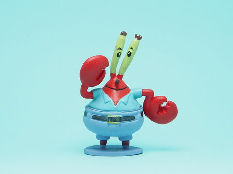 Indonesia - November 3, 2025 : Mini toy of action figure at outdoor with blurred background. Miniature photography concept design. Minifigure of Spongebob Squarepants character from cartoon film.