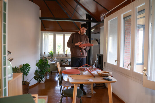  handyman assembling a chair in a new home