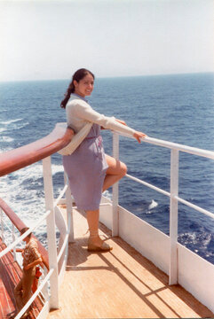 Woman enjoying ocean view from ship deck