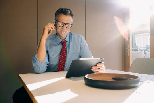 A man talking on a mobile phone in the office