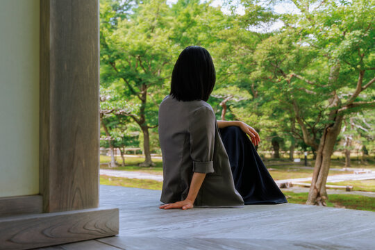 A modern urban woman experiencing slow life at an ancient temple.