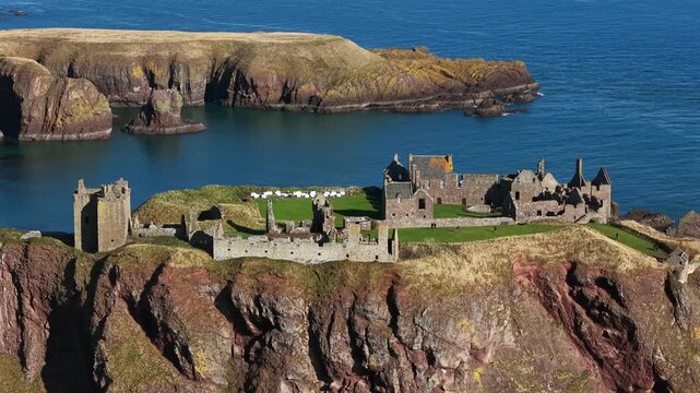 Beautiful cinematic Aerial footage of Dunnottar Castle and Dramatic Cliffs, Stonehaven Scotland &ndash; Historic Medieval Fortress on the North Sea	