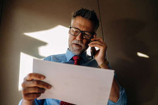 A man talking on a mobile phone in the office