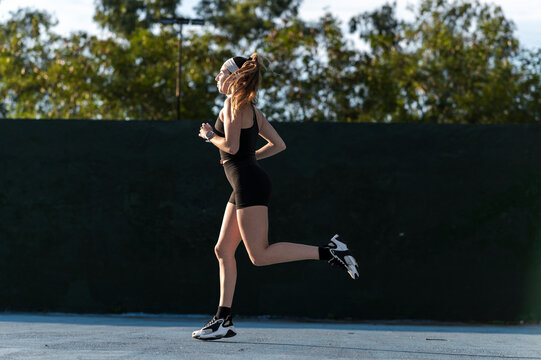 Urban athlete jogging to warm up on sports court