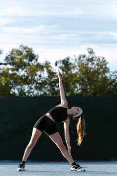 Triangle pose stretch with an arm raised toward the sky