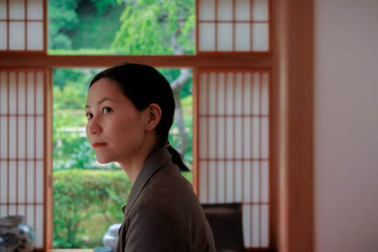A contemplative woman in a Zen meditation room.