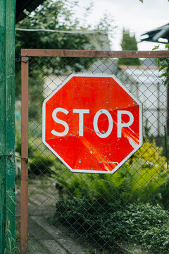 A sign installed in a fenced area.