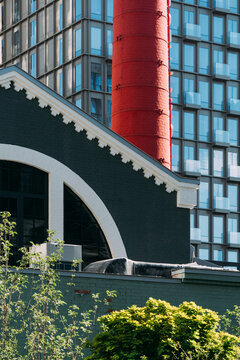 Old factory building near modern office tower in city