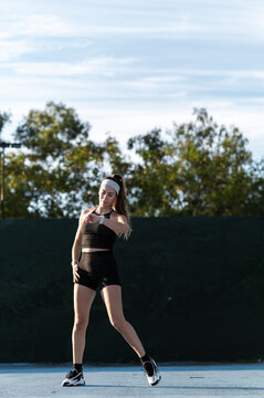 Attentive athlete checking smartwatch on outdoor court