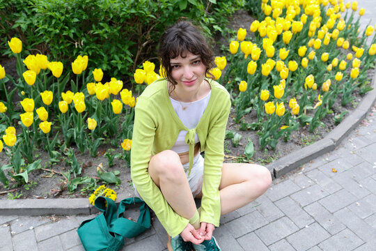 A young woman is walking in the park.