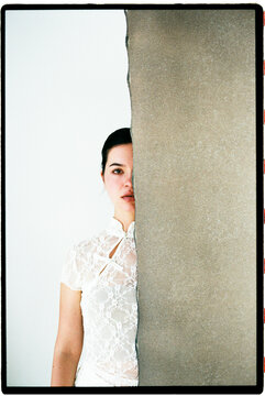 Woman behind a textured wall