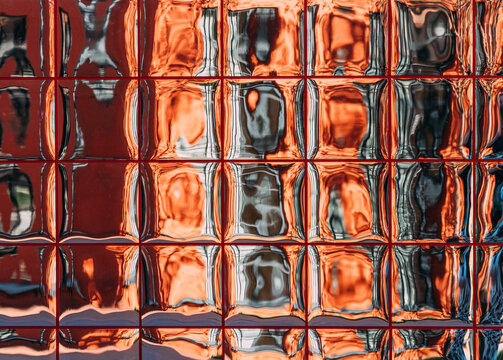 Reflection on a glass surface in a city setting during the day