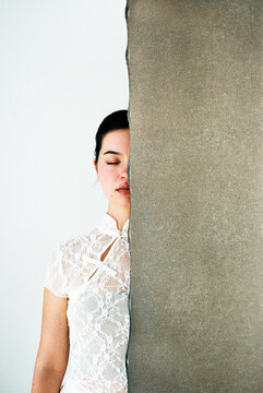 Woman's face partially hidden by background
