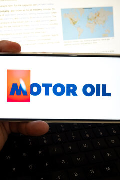 Hand holding device displaying motor oil concept