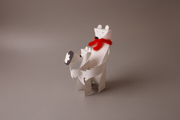 Paper polar bear holding polar bear cub on grey background. Handmade paper craft studio photography. Parent and child relationship, family care and winter concept. © Elena