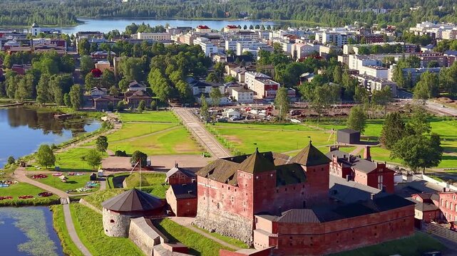 Aerial video of H&auml;meenlinna castle and city park in Finland, slow cinematic pan with parallax. 