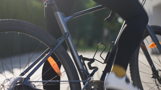 Cyclist clipping cycling shoe into bicycle pedal
