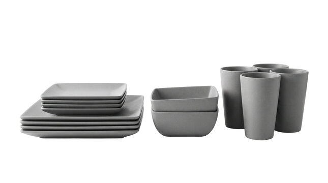 A set of grey modern minimalist dinnerware including square plates bowls and drinking cups on white background