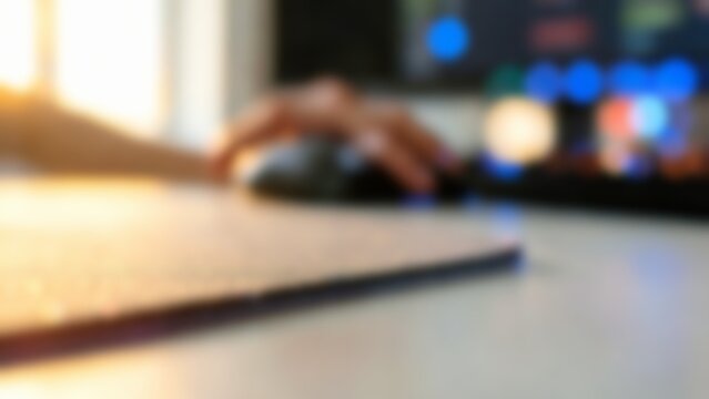 Blurred hand using computer mouse with soft glow for website header