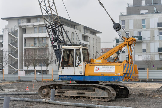 Nancy, France - March 1st 2019 : View on a yellow crawler crane Sennebogen S10-20 for special foundations on a construction site before the construction of a residential building.