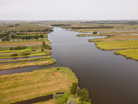 Aerial view of a rural Netherlands village surrounded by canals and agricultural fields