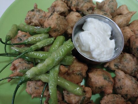 Authentic Front View Indian Crispy Fried Pakora with Curd and Green Chilies