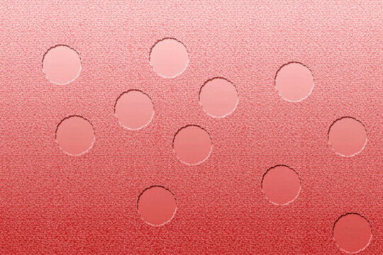 Perforated pink surface with circular openings a textured background pattern holes texture