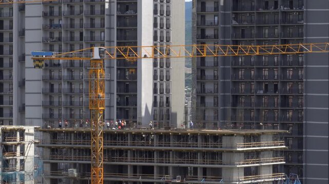 Builders are working on the construction of a high-rise building