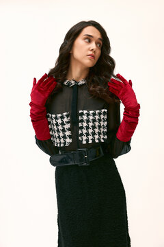 Young woman exuding confidence and style in a chic fashion statement with striking accessories