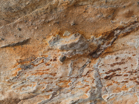 Topographic sandstone rock texture showcasing natural relief layers and terrain contours.
