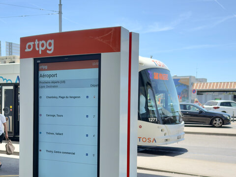 Geneva, Switzerland - July 6 2026: A public transport information TPG display shows upcoming departures, including Aeroport.