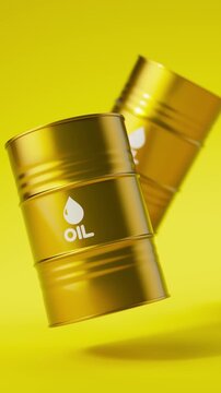 Two gold metal oil barrels floating on a yellow background for petroleum industry concept. Vertical video.