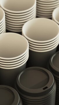 Camera pan over a stack of cups and lids in black for cafe packaging and takeaway beverage concept. Vertical video.