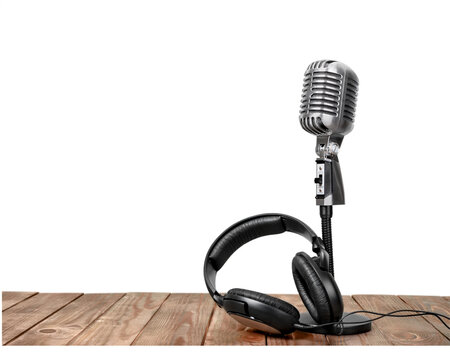 Vintage style microphone and studio headphones resting on a wooden surface on transparent background retro headset audio equipment sound recording