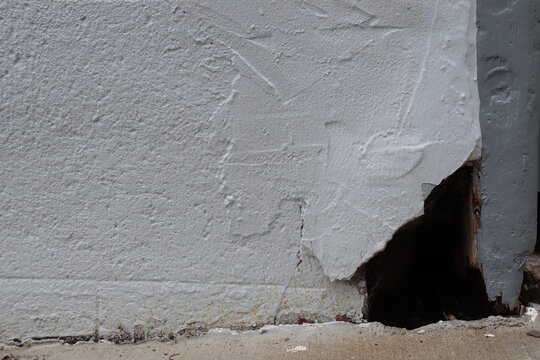 Outdoor old brick wall background. Old house problem and hole in the facade. House renovation and foundation crack. Construction industry and outdoor renovation for old house.