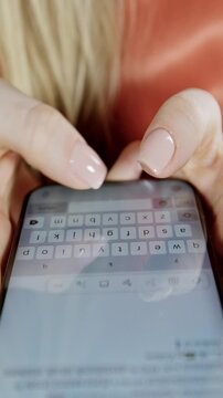 Female hands using smart phone to type or browse in vertical