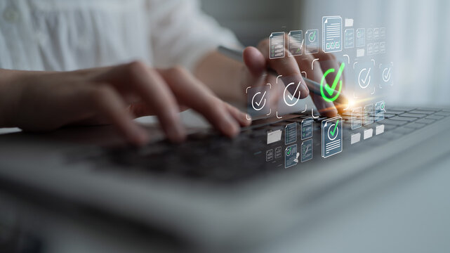 Close-up of Human Hands Typing on Laptop with Digital Checkmarks and Document Icons Representing Approval Process in Modern Workspace Sigmoid