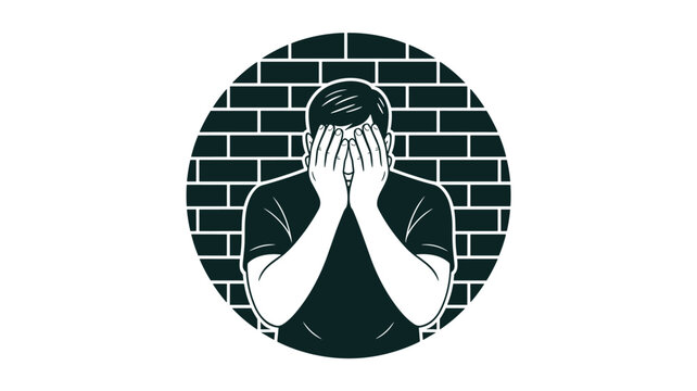 Depressed young man covering his face with his hands against a brick wall background, grief and shame concept.