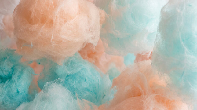 Soft ethereal cotton candy clouds in delicate peach, salmon and turquoise cyan hues creating a dreamy abstract texture with wispy fibrous details