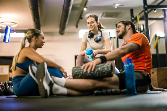 Athletic partners and friends relaxing in the gym with recovery gear