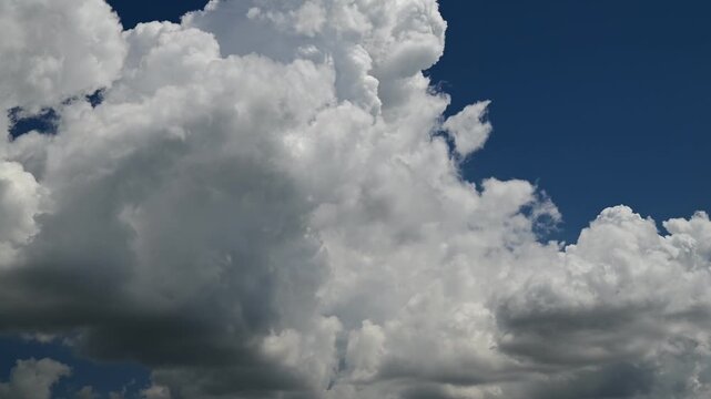 timelapse of white cumulus clouds in a clear blue sky