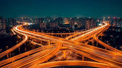 Aerial Night View of a Multi-Level Highway Interchange with City Lights © alexis8448
