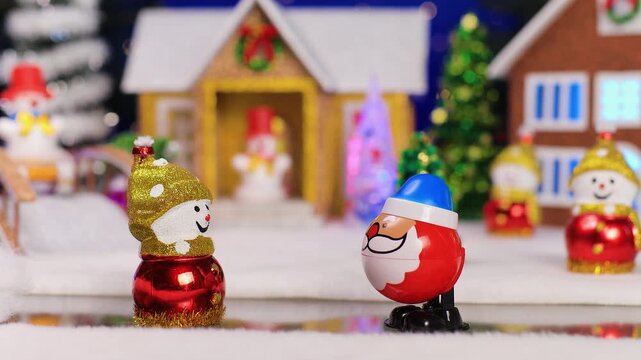 Against the backdrop of a Christmas village, an unusual Santa Claus comes running to a snowman
